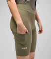 women-cycling-cargo-bibshort-military-green-odyssey-side-hand-pedaled.webp